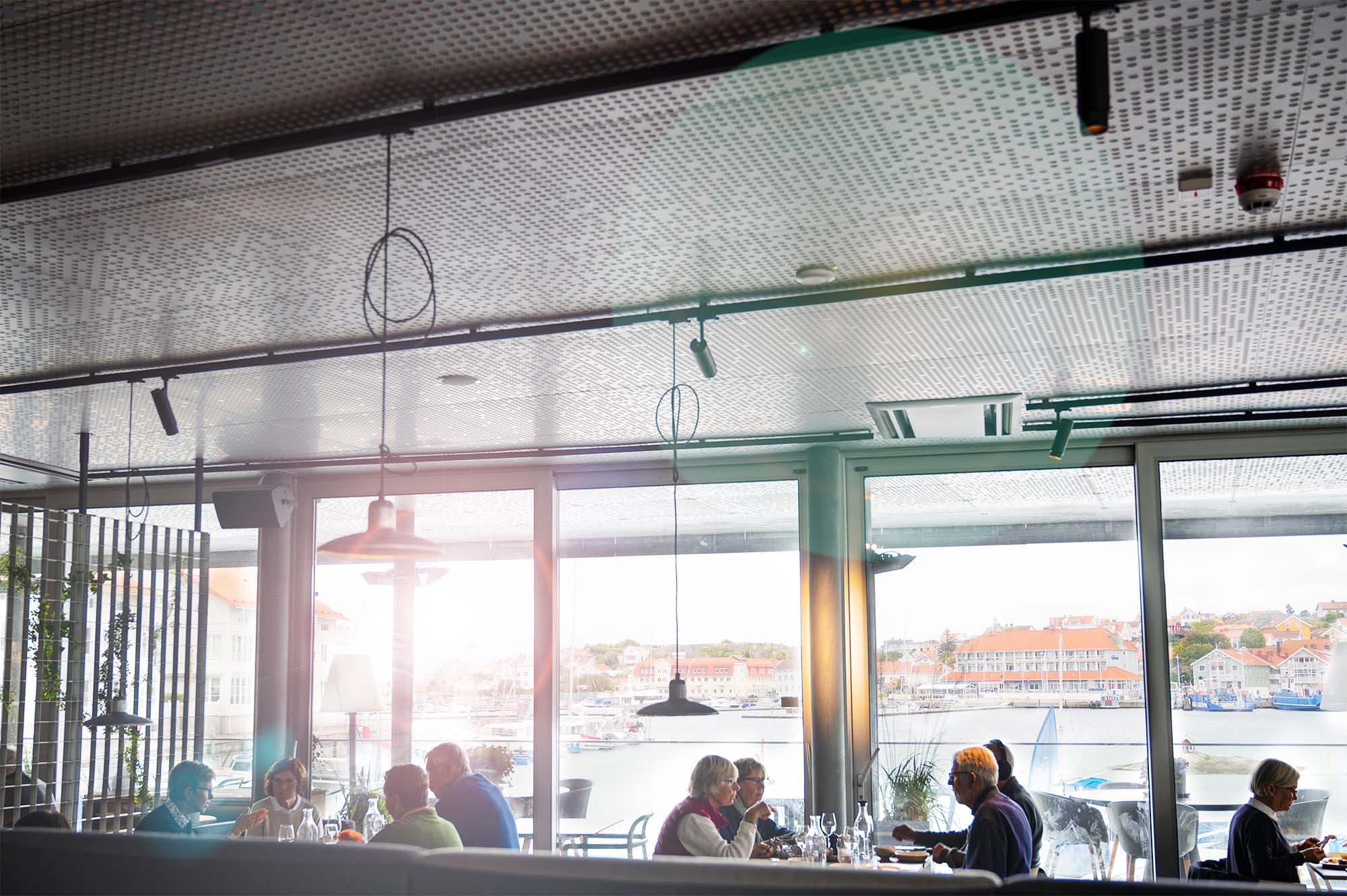 Perforerat akustiktak i restaurang med hamnutsikt